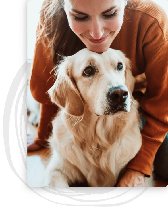 A woman rests her chin on top of her Golden Retriever's head