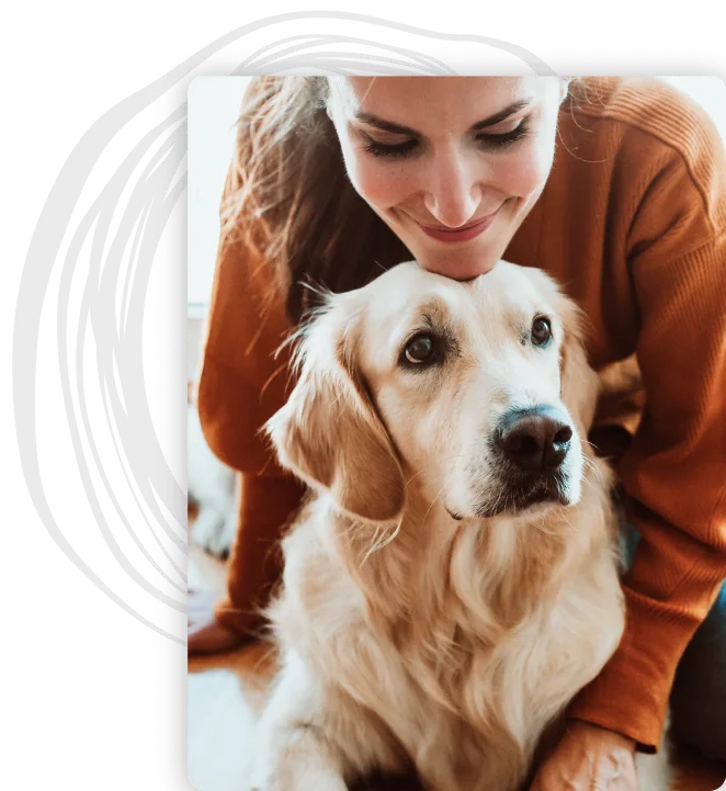 A woman rests her chin on top of her Golden Retriever's head
